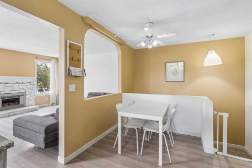 212 Whitman Place Ne, Calgary, AB - Indoor Photo Showing Other Room With Fireplace