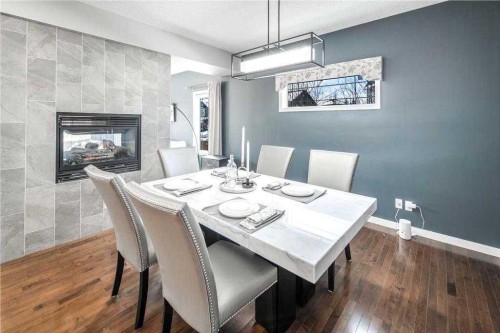 5 Panatella Square Nw, Calgary, AB - Indoor Photo Showing Dining Room With Fireplace