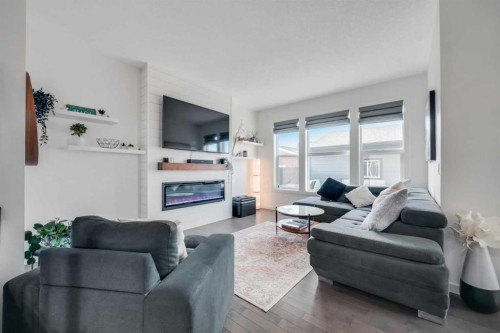 19 Marquis Gardens Se, Calgary, AB - Indoor Photo Showing Living Room With Fireplace