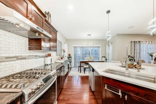 719 Panamount Boulevard Nw, Calgary, AB - Indoor Photo Showing Kitchen With Double Sink With Upgraded Kitchen