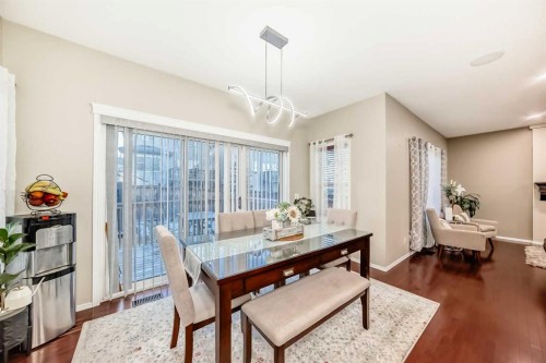 719 Panamount Boulevard Nw, Calgary, AB - Indoor Photo Showing Dining Room With Fireplace