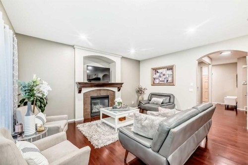 719 Panamount Boulevard Nw, Calgary, AB - Indoor Photo Showing Living Room With Fireplace