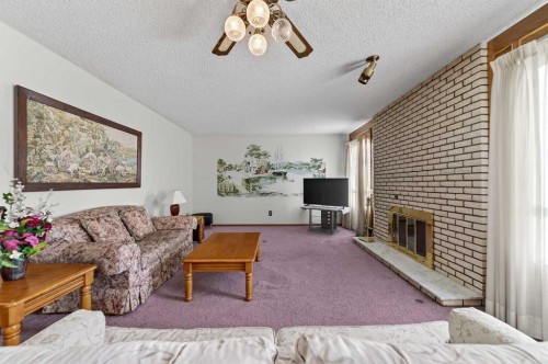 455 24 Avenue Ne, Calgary, AB - Indoor Photo Showing Living Room With Fireplace