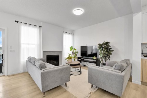 179 Willow Place, Cochrane, AB - Indoor Photo Showing Living Room With Fireplace