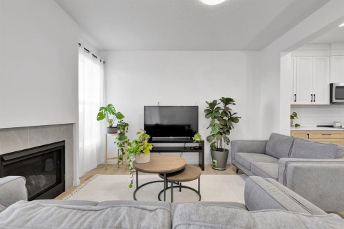 179 Willow Place, Cochrane, AB - Indoor Photo Showing Living Room With Fireplace
