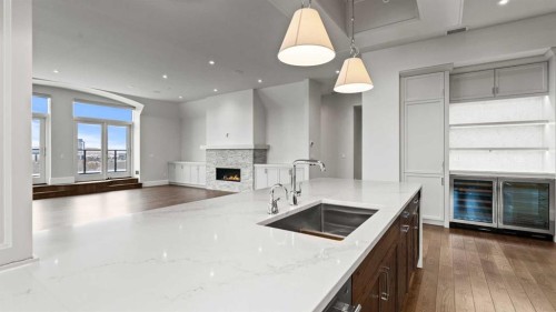 502-221 Quarry Way Se, Calgary, AB - Indoor Photo Showing Kitchen With Fireplace