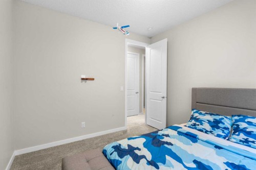 29 Magnolia Manor Se, Calgary, AB - Indoor Photo Showing Bedroom