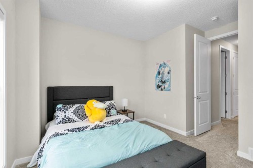 29 Magnolia Manor Se, Calgary, AB - Indoor Photo Showing Bedroom