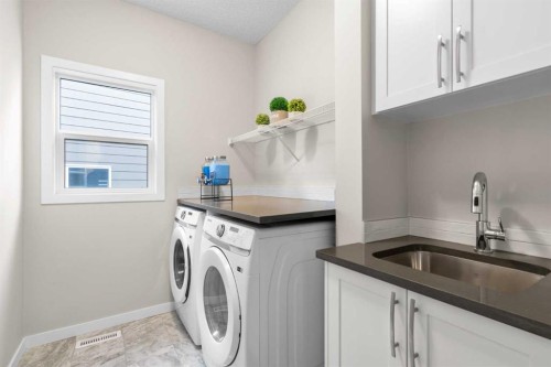 29 Magnolia Manor Se, Calgary, AB - Indoor Photo Showing Laundry Room