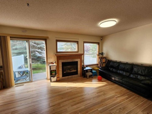 9 Country Hills Rise Nw, Calgary, AB - Indoor Photo Showing Living Room With Fireplace