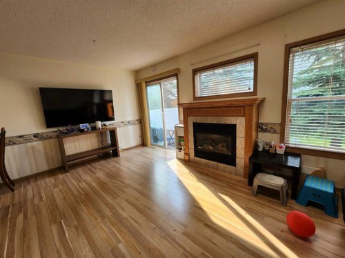 9 Country Hills Rise Nw, Calgary, AB - Indoor Photo Showing Living Room With Fireplace