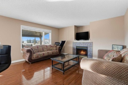 82 Martha'S Meadow Close Ne, Calgary, AB - Indoor Photo Showing Living Room With Fireplace