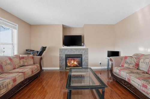 82 Martha'S Meadow Close Ne, Calgary, AB - Indoor Photo Showing Living Room With Fireplace