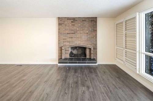 4712 Vegas Road Nw, Calgary, AB - Indoor Photo Showing Living Room With Fireplace