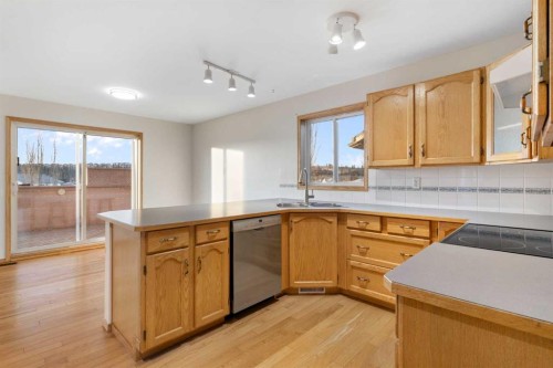 165 Quigley Drive, Cochrane, AB - Indoor Photo Showing Kitchen With Double Sink