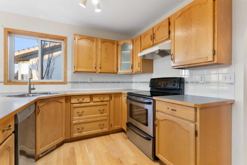165 Quigley Drive, Cochrane, AB - Indoor Photo Showing Kitchen With Double Sink