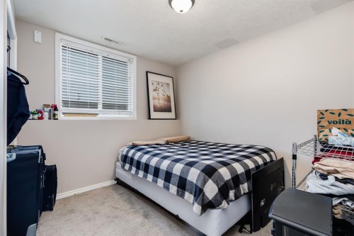 504-620 Luxstone Landing Sw, Airdrie, AB - Indoor Photo Showing Bedroom