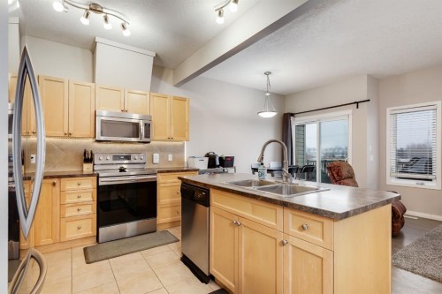 504-620 Luxstone Landing Sw, Airdrie, AB - Indoor Photo Showing Kitchen With Double Sink