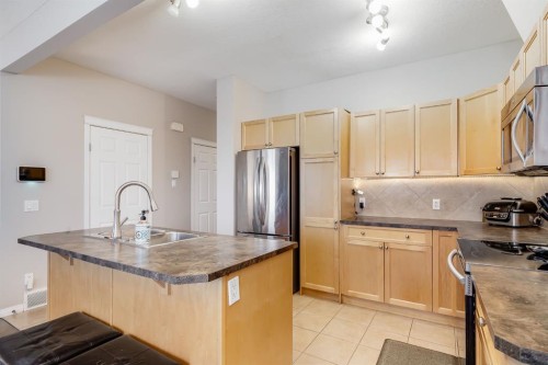 504-620 Luxstone Landing Sw, Airdrie, AB - Indoor Photo Showing Kitchen With Stainless Steel Kitchen With Double Sink