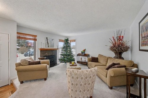34 Woodglen Crescent Sw, Calgary, AB - Indoor Photo Showing Living Room With Fireplace
