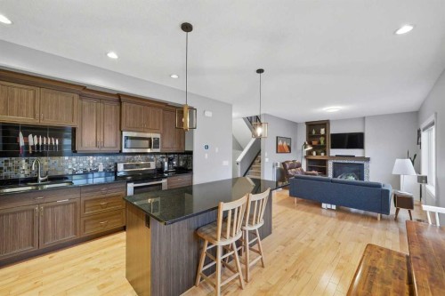 136 Wildrose Crescent, Strathmore, AB - Indoor Photo Showing Kitchen With Fireplace With Double Sink