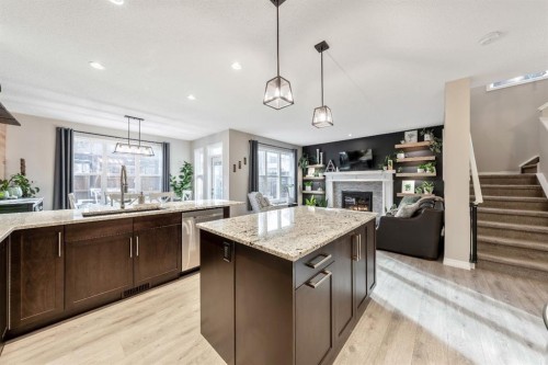 159 Riviera View, Cochrane, AB - Indoor Photo Showing Kitchen With Fireplace With Double Sink