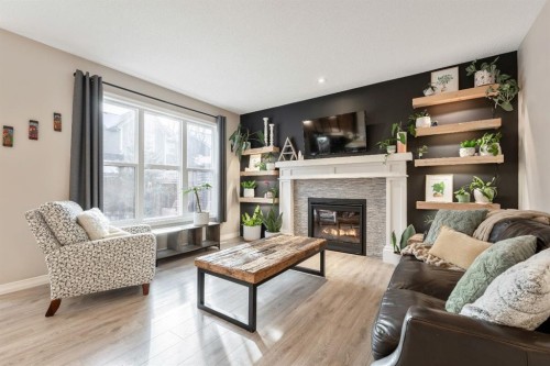 159 Riviera View, Cochrane, AB - Indoor Photo Showing Living Room With Fireplace