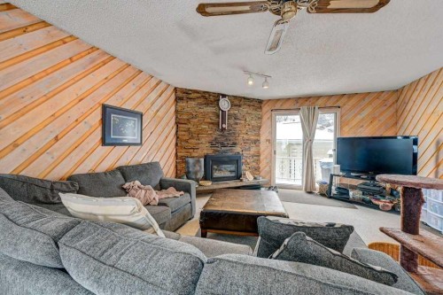 1455 Russell Road Ne, Calgary, AB - Indoor Photo Showing Living Room With Fireplace