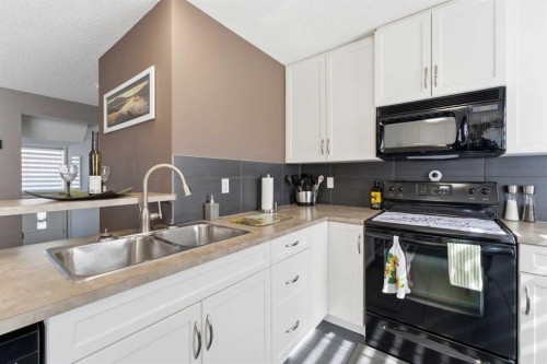 59 New Brighton Common Se, Calgary, AB - Indoor Photo Showing Kitchen With Double Sink