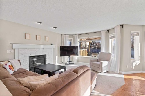 21 Wilson Road Ne, Langdon, AB - Indoor Photo Showing Living Room With Fireplace