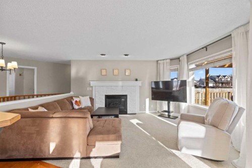 21 Wilson Road Ne, Langdon, AB - Indoor Photo Showing Living Room With Fireplace
