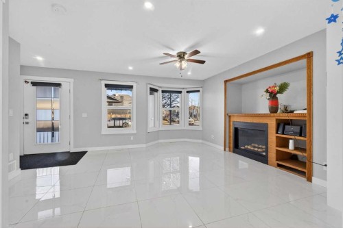 49 Taravista Way Ne, Calgary, AB - Indoor Photo Showing Other Room With Fireplace