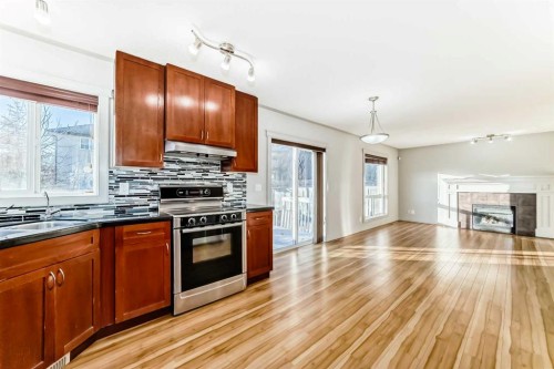 1156 Sherwood Boulevard Nw, Calgary, AB - Indoor Photo Showing Kitchen With Fireplace With Double Sink