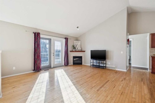 100B Westview Drive, Nanton, AB - Indoor Photo Showing Living Room With Fireplace