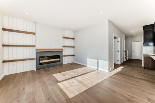 504 Heritage Boulevard, Cochrane, AB - Indoor Photo Showing Living Room With Fireplace