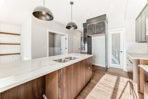 504 Heritage Boulevard, Cochrane, AB - Indoor Photo Showing Kitchen With Double Sink