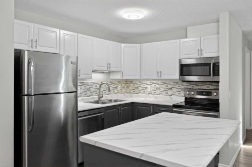 1408-1000 Somervale Court Sw, Calgary, AB - Indoor Photo Showing Kitchen With Stainless Steel Kitchen With Double Sink With Upgraded Kitchen