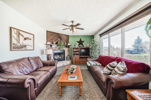 314 Mckinnon Drive, Carseland, AB - Indoor Photo Showing Living Room With Fireplace