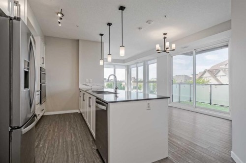 309-2231 Mahogany Boulevard Se, Calgary, AB - Indoor Photo Showing Kitchen With Upgraded Kitchen