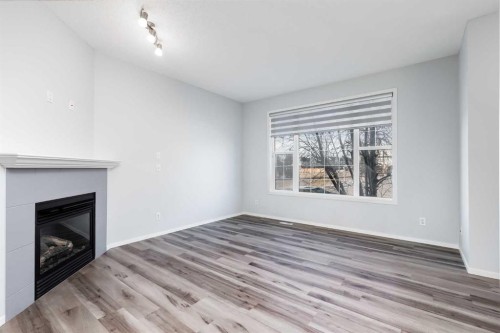 48 Covemeadow Road Ne, Calgary, AB - Indoor Photo Showing Living Room With Fireplace