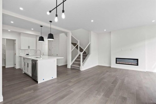 108 Waterford Way, Chestermere, AB - Indoor Photo Showing Kitchen With Fireplace With Double Sink