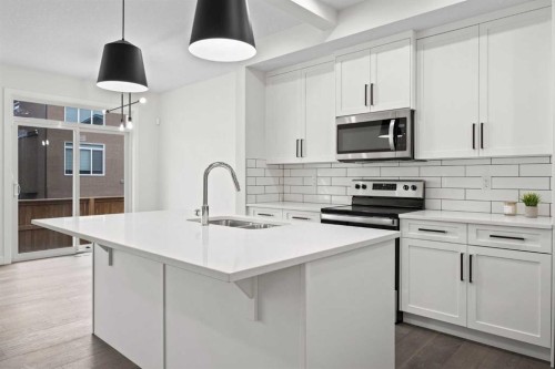 108 Waterford Way, Chestermere, AB - Indoor Photo Showing Kitchen With Double Sink With Upgraded Kitchen