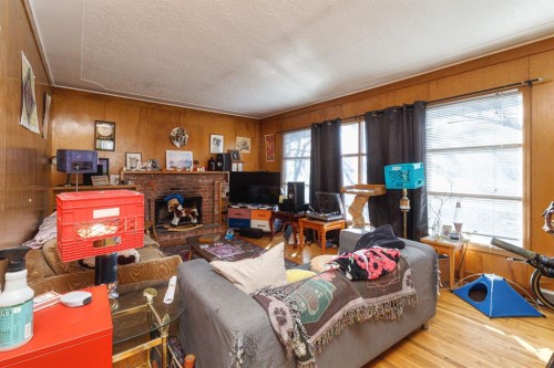 2824 Parkdale Boulevard Nw, Calgary, AB - Indoor Photo Showing Living Room With Fireplace