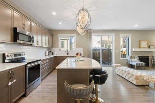 17 Carrington Manor Nw, Calgary, AB - Indoor Photo Showing Kitchen With Fireplace With Upgraded Kitchen