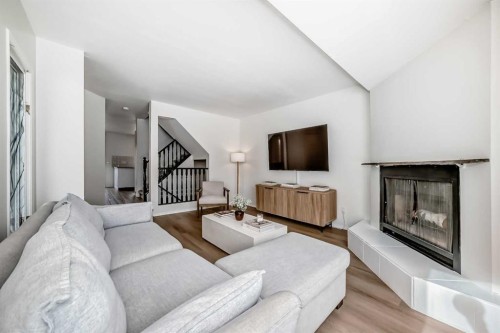 212 Cedarbrook Bay Sw, Calgary, AB - Indoor Photo Showing Living Room With Fireplace