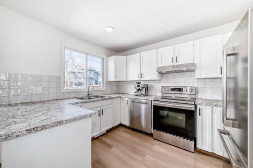 212 Cedarbrook Bay Sw, Calgary, AB - Indoor Photo Showing Kitchen With Double Sink With Upgraded Kitchen