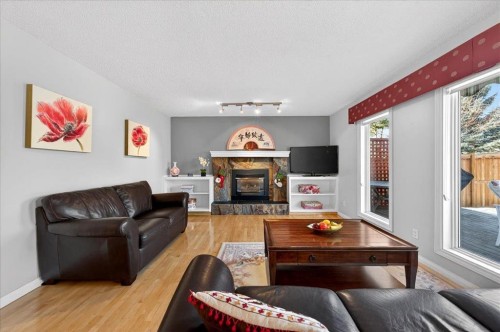 137 Woodbrook Road Sw, Calgary, AB - Indoor Photo Showing Living Room With Fireplace