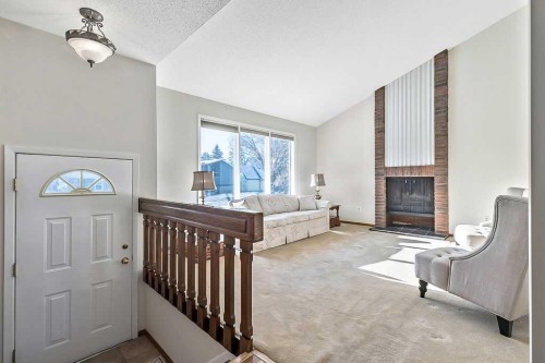107 Lock Crescent, Okotoks, AB - Indoor With Fireplace