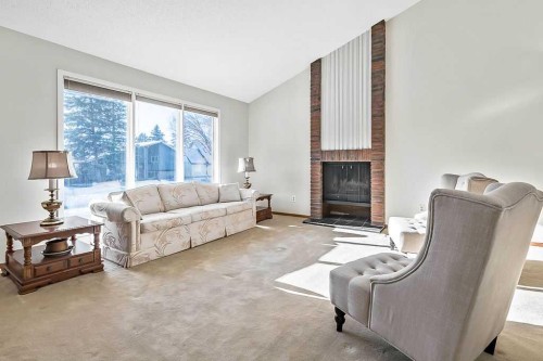 107 Lock Crescent, Okotoks, AB - Indoor Photo Showing Living Room With Fireplace
