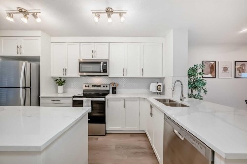 307-474 Seton Circle Se, Calgary, AB - Indoor Photo Showing Kitchen With Stainless Steel Kitchen With Double Sink With Upgraded Kitchen